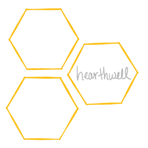 three golden outlines of hexagons arranged in a flag-shaped triangular formation with the script "hearthwell" written in grey within the far right hexagon